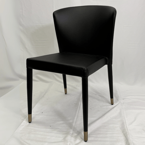 Capri black commercial dining chair with upholstered seat and back, metal-tipped legs.