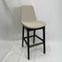 Beige boucle Eiffel HB barstool with black legs and brass footrest, back-supported for modern dining.