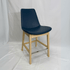 Eiffel HB blue leather bar stool with back support, light wood frame and chrome footrest.