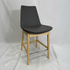 Grey leather high-back Eiffel counter stool with natural wood legs and chrome footrest.
