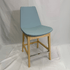 Eiffel HB light blue leather bar stool with backrest, natural wood legs and chrome footrest.